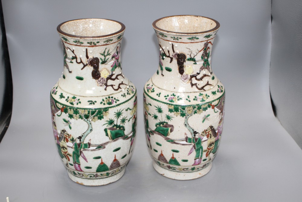 A pair of Chinese crackleware vases, decorated with figures in continuous landscapes, height 33cm